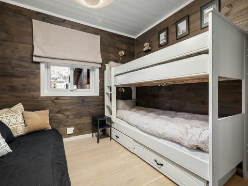 A bedroom with bunk beds and a couch