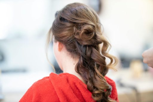 Close-up of an elegant bridal hairstyle featuring curls and a braid, captured from the back.