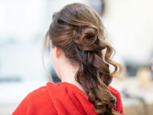 Close-up of an elegant bridal hairstyle featuring curls and a braid, captured from the back.