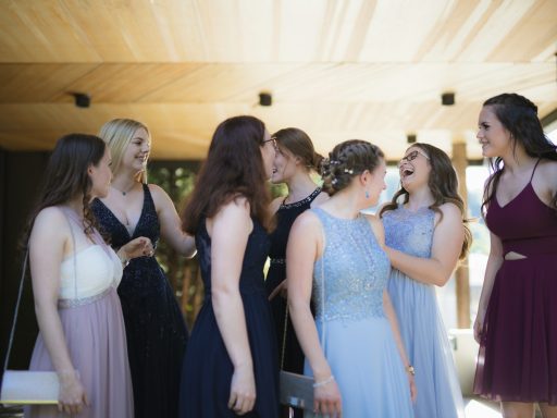 woman in white wedding gown standing beside woman in black sleeveless dress