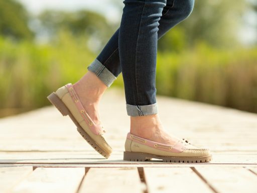 A person walking on a wooden platform in a park