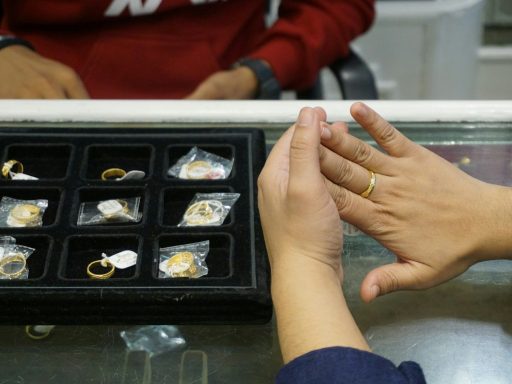 a woman is putting a ring on another woman's finger