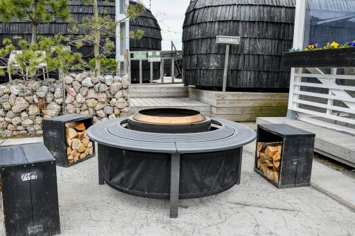 Modern outdoor fire pit with seating and firewood