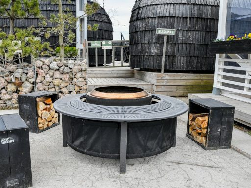 Modern outdoor fire pit with seating and firewood