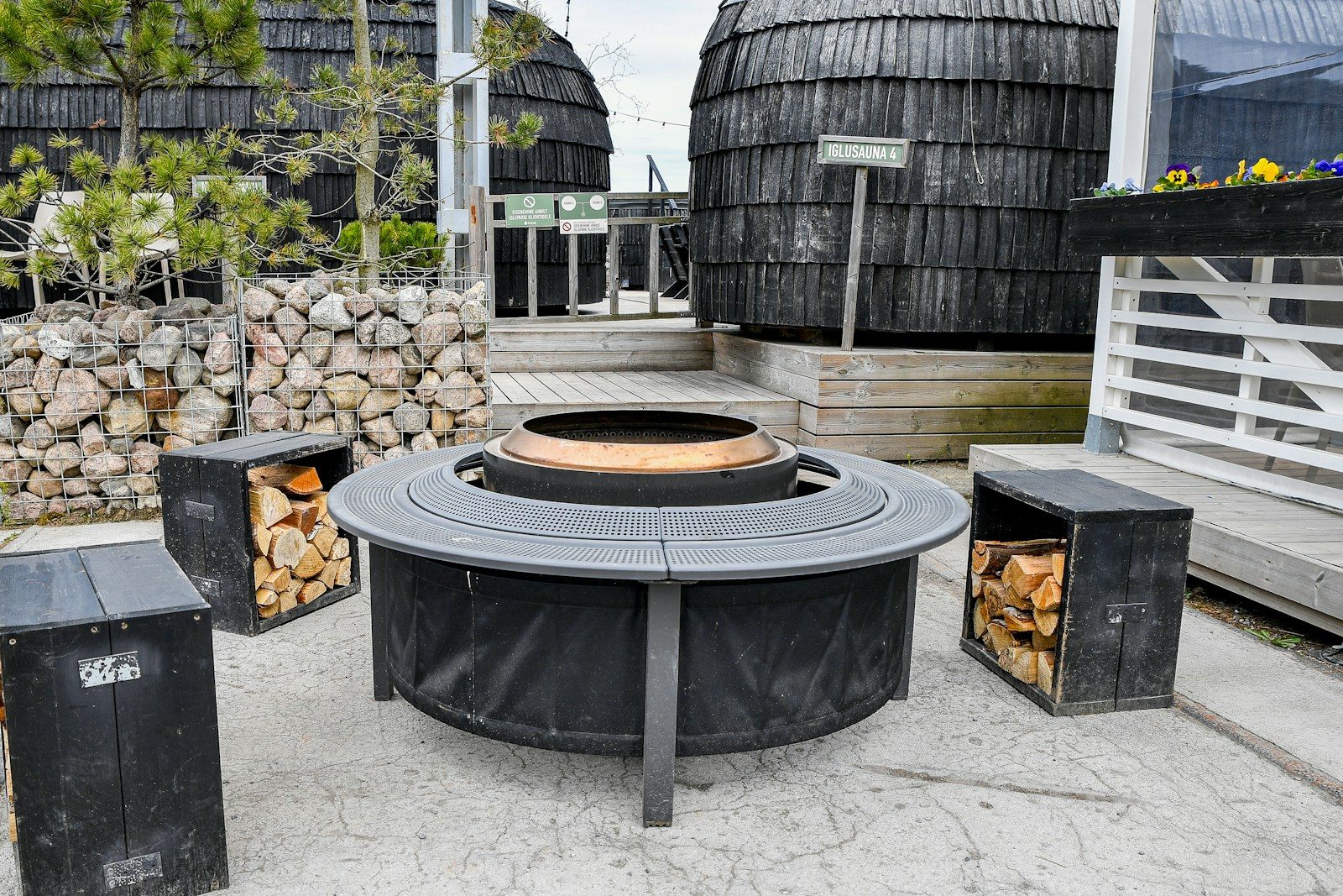 Modern outdoor fire pit with seating and firewood