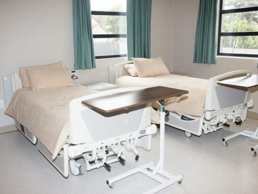 white hospital bed near window